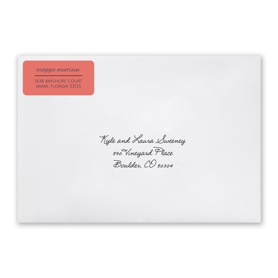 white envelope with coral address label and handwritten text