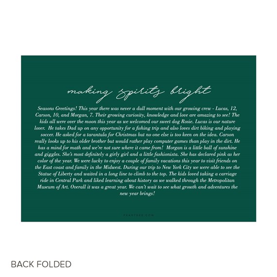 Folded Christmas card back with dark green background, white script heading and white body text