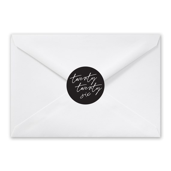 white envelope with black circular seal and handwritten text