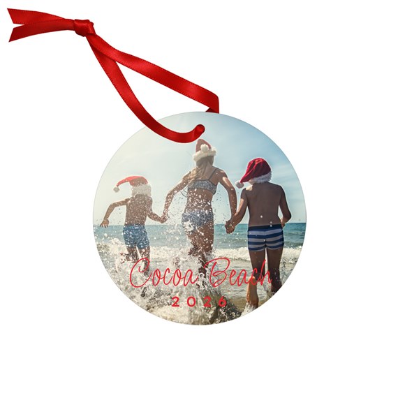 round ornament with beach scene and red ribbon