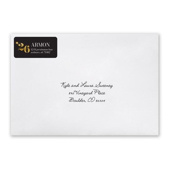 black address label with gold text on white envelope