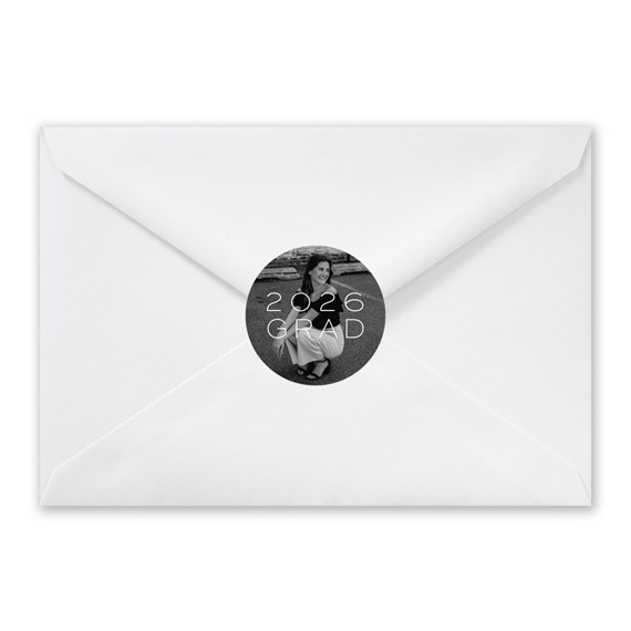 white envelope with round photo seal and text