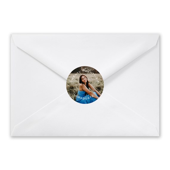 white envelope with circular photo seal and text