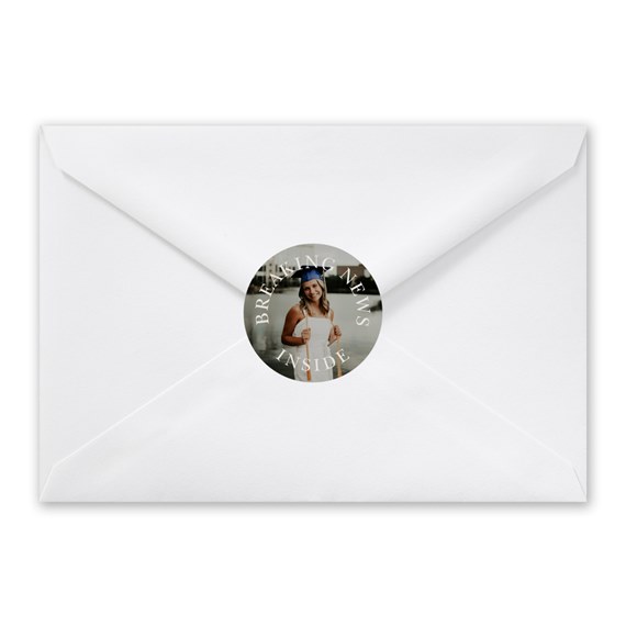 white envelope with circular photo seal and text