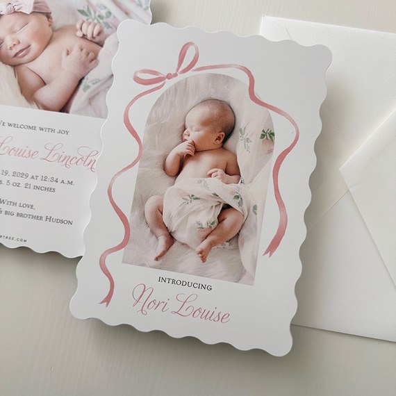 announcement card with photo placeholder, scalloped edges, pink ribbon