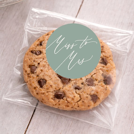 cookie in plastic bag with green sticker and white script