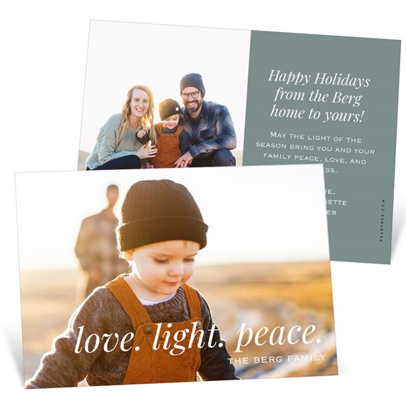 Holiday photo card with child in beanie and brown overalls, white 