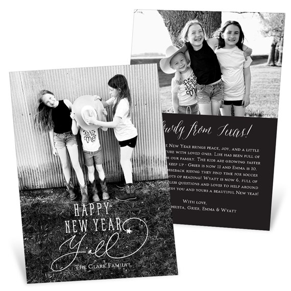 Black-and-white New Year photo card showing three children in cowboy boots and a cowboy hat with a script 