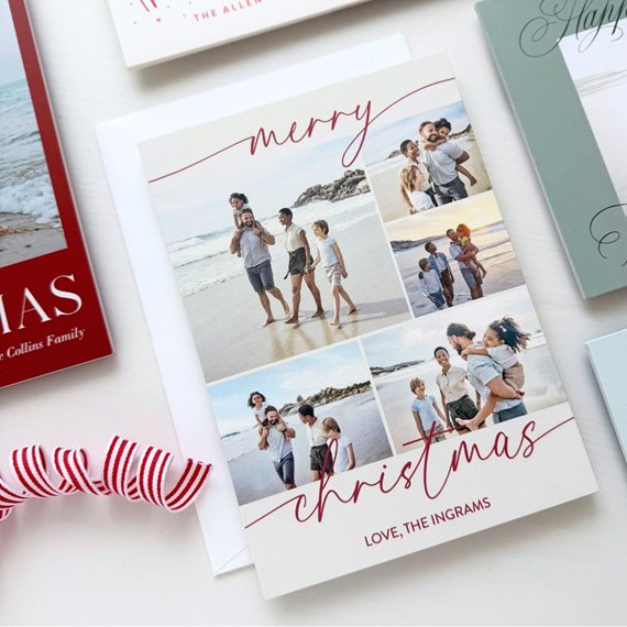 Folded holiday photo card with beach family photo collage and red script "merry christmas" on white background