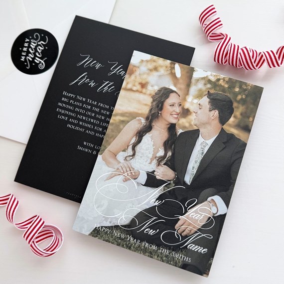 New Year photo greeting card with couple in wedding attire, cursive overlay, black insert and white envelope