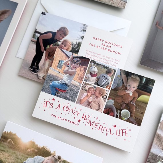 square holiday photo collage card with children photos and red holiday greeting on white background