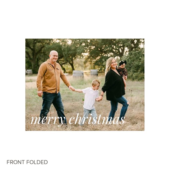 family of four walking outdoors on a Christmas card with 'merry christmas' text