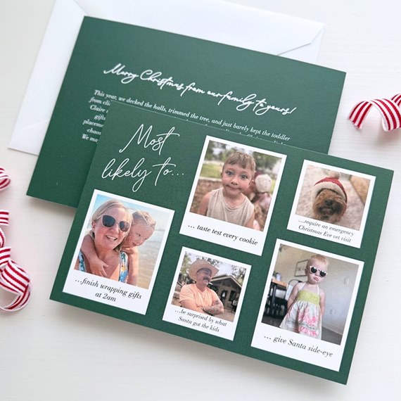 dark green Christmas photo card with six polaroid-style family photos, white script title and captions, shown with white envelope
