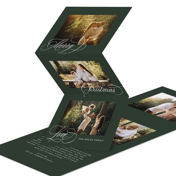 dark green accordion Christmas photo card with white calligraphy and family pictures
