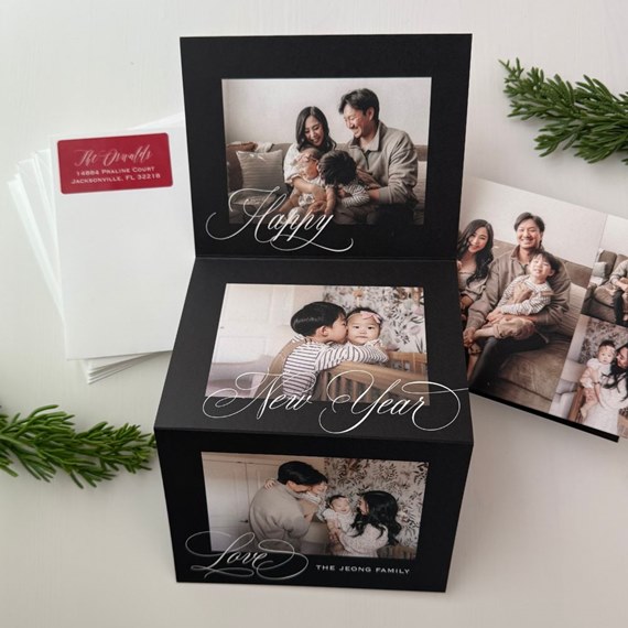 Black folded A6 photo card with three family photos and white calligraphy 