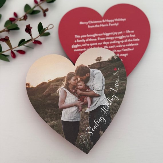 heart-shaped holiday card with family photo and text