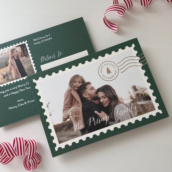 Christmas photo postcard with dark green scalloped stamp border, white photo area with family portrait and gold holiday postmark; back shows address block and greeting