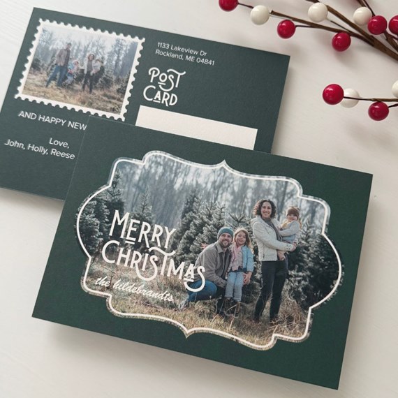 Vintage-style green Christmas postcard with family photo, white decorative frame and 'Merry Christmas' greeting; back shows postcard layout and address block
