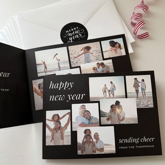 Black New Year collage photo card with white "happy new year" text, family beach photos and white envelopes