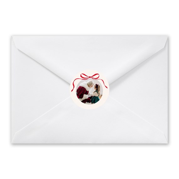 white envelope with circular photo placeholder and red bow seal