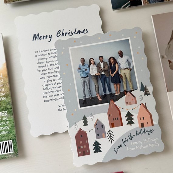 holiday photo card with scalloped edges, family portrait and illustrated winter village