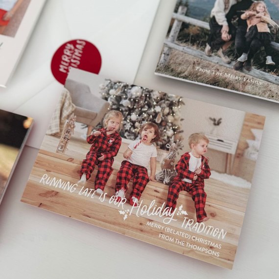 holiday card with children in plaid pajamas and text area