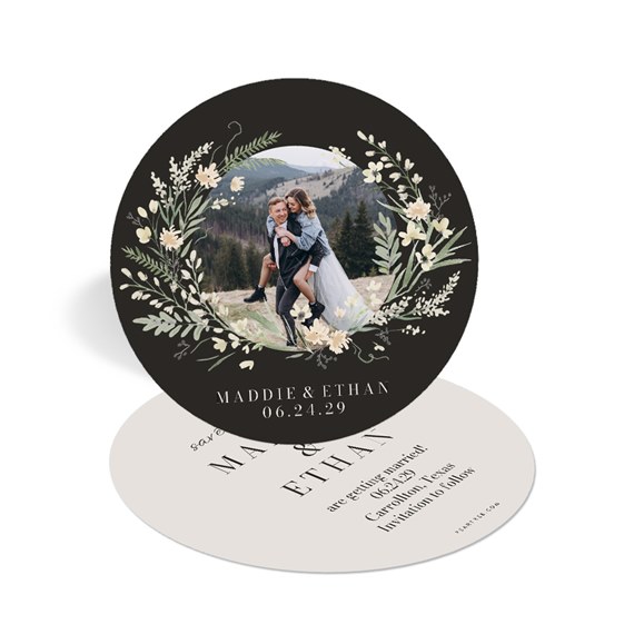 circular save-the-date card with floral wreath and photo area