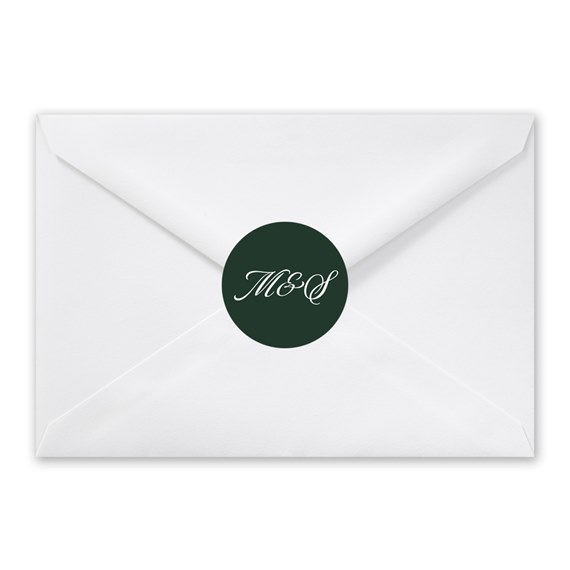 white envelope with dark green circular seal and white script initials