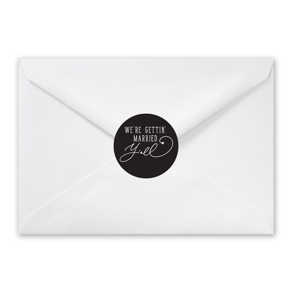 white envelope with black round seal and decorative text