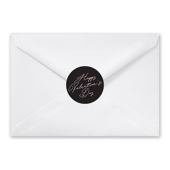white envelope with black round seal and scripted text