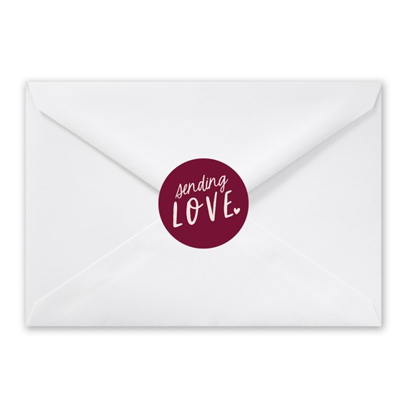 white envelope with burgundy seal and text