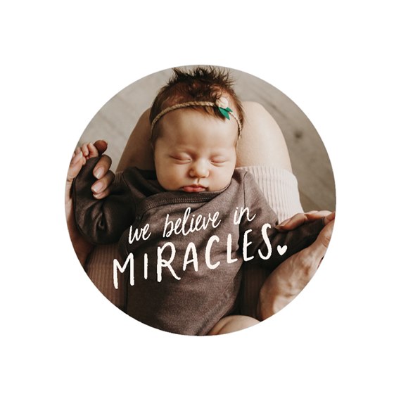 round envelope seal with text and baby photo area