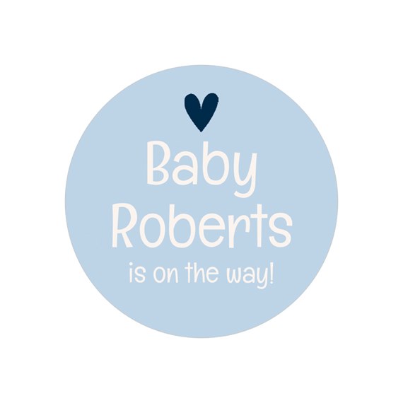 round sticker with baby announcement text and heart