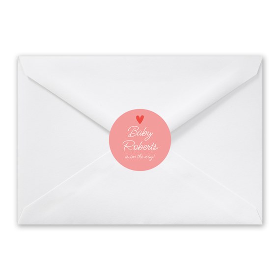 white envelope with pink circular seal and text