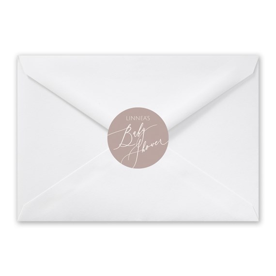 white envelope with beige seal and white script text