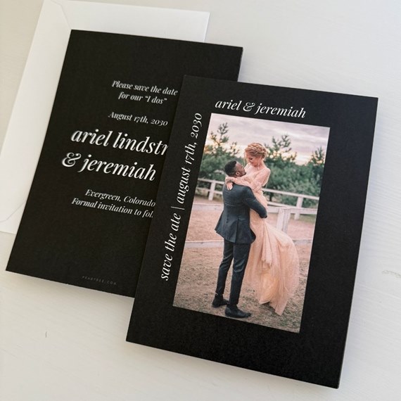 black save-the-date card with photo area and white text