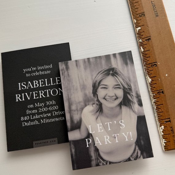 two graduation announcements, one black with white text, one with photo and text