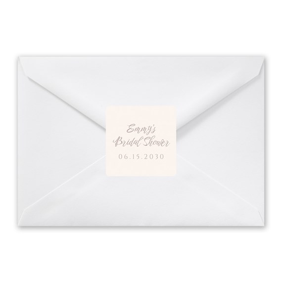 white envelope with beige sticker and script text