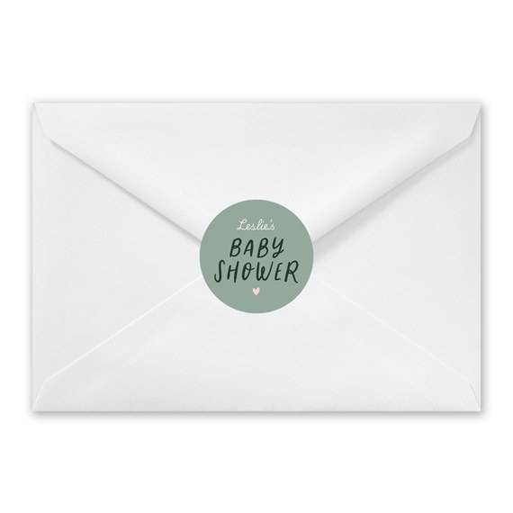 white envelope with circular baby shower seal
