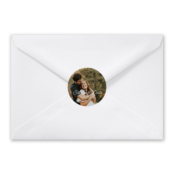 white envelope with circular photo seal and text