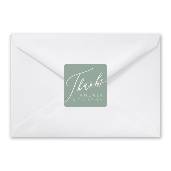 white envelope with green seal and script text