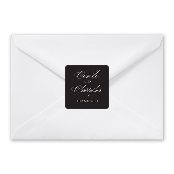 white envelope with black seal and script text