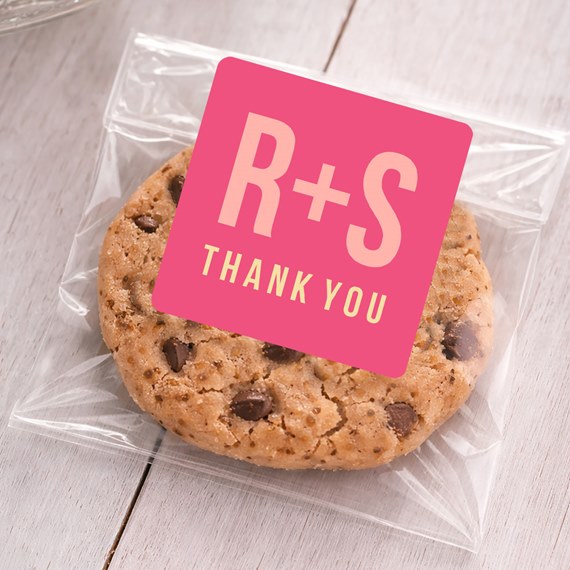 pink sticker with text on a cookie in a plastic bag
