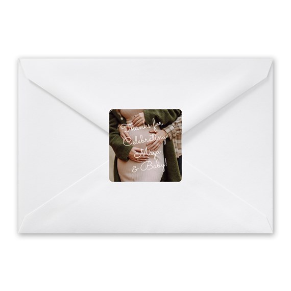 white envelope with a sticker that has decorative text