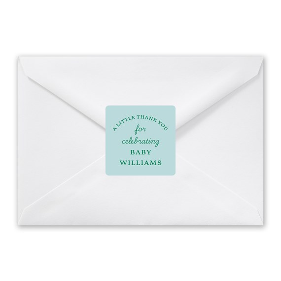 white envelope with teal label and text