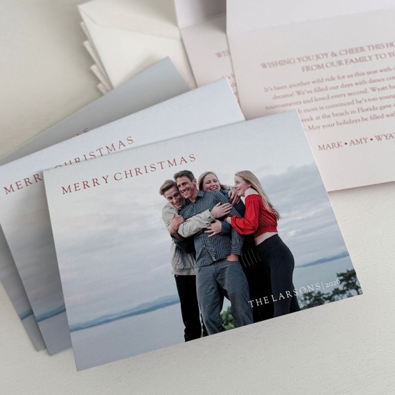 photo area with four people hugging, 'MERRY CHRISTMAS' text