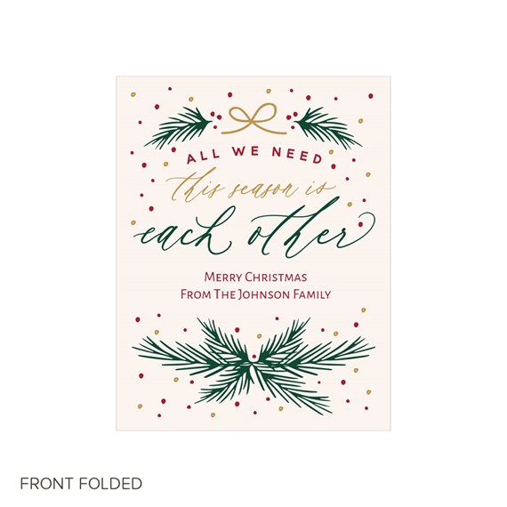 Christmas card with pine branches and decorative text, photo placeholder