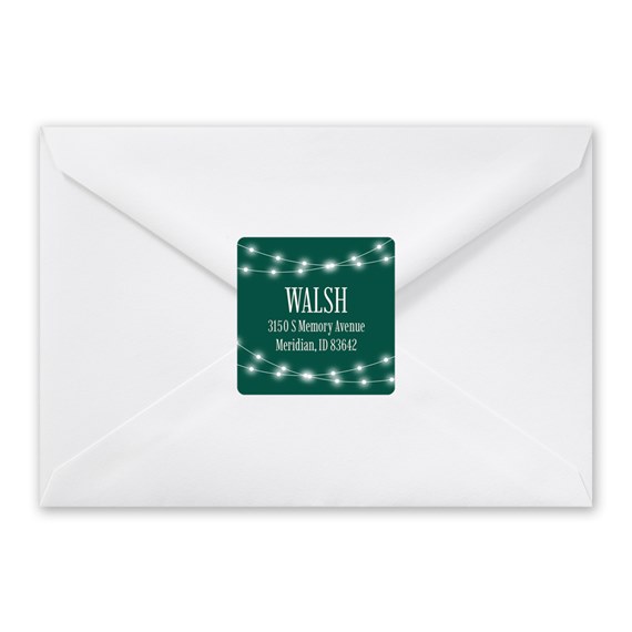 address label with string lights on dark green background