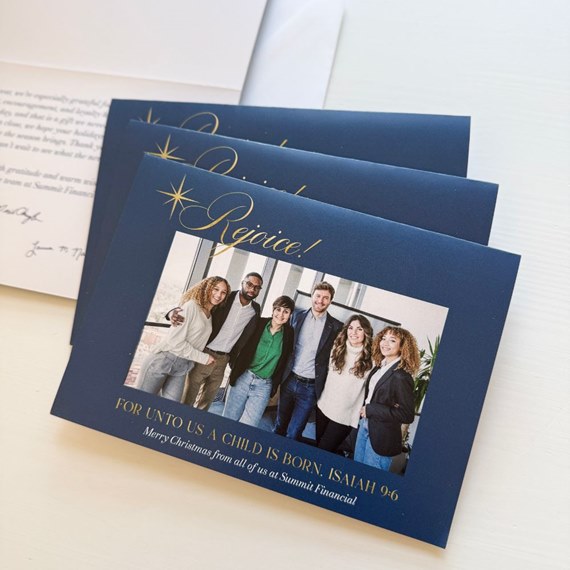 navy blue holiday card with photo area and gold text