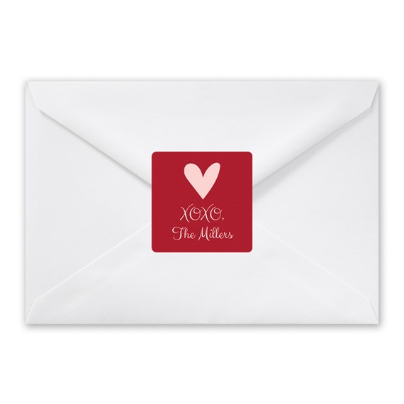 white envelope with red seal and heart design